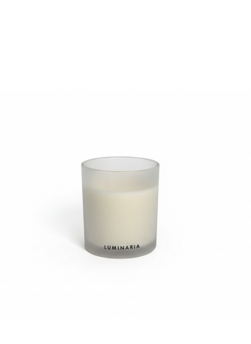 Frosted glass candle jar with 'Luminaria' branding on a white background.
