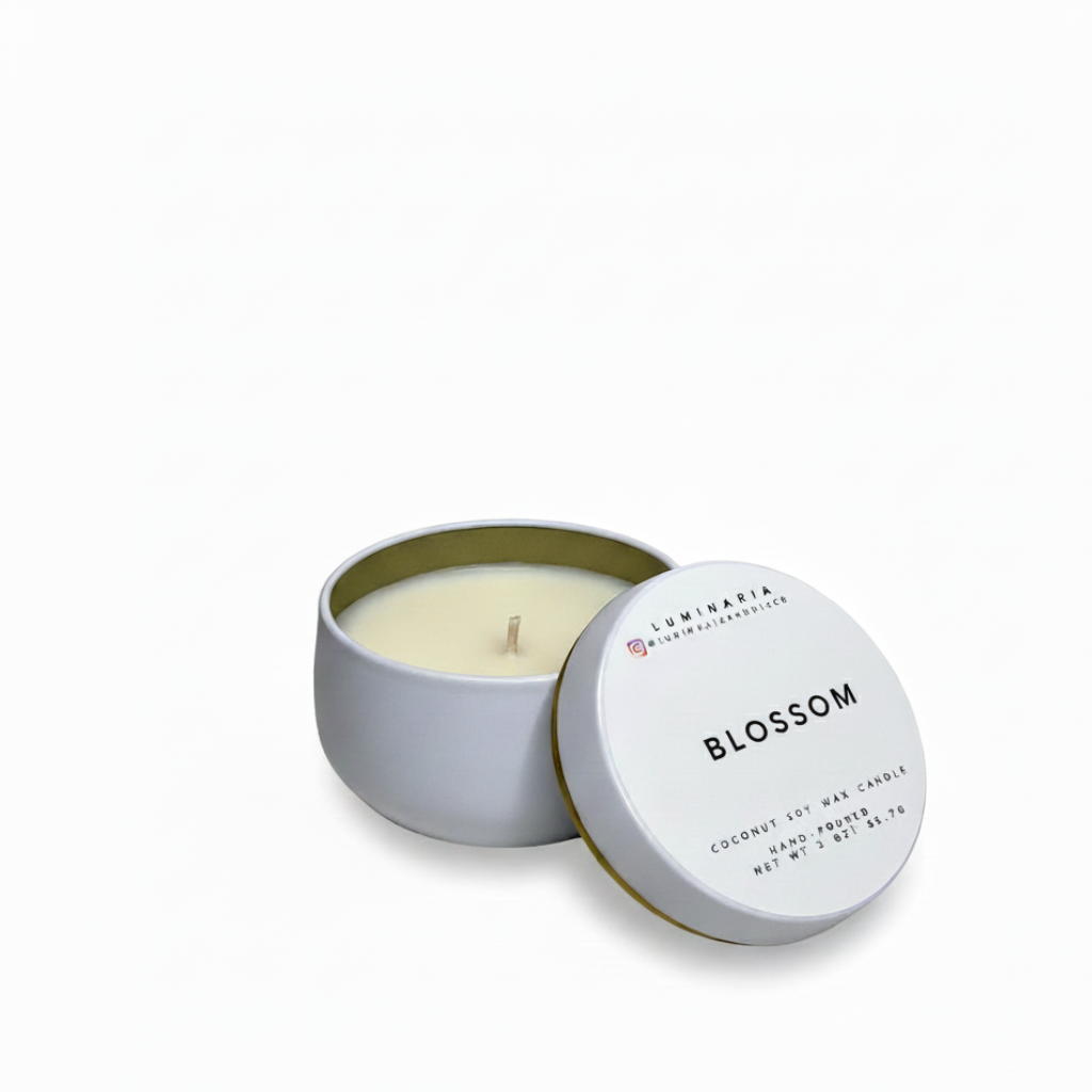 Open white metal tin candle with lid labeled 'Blossom' placed on a white background