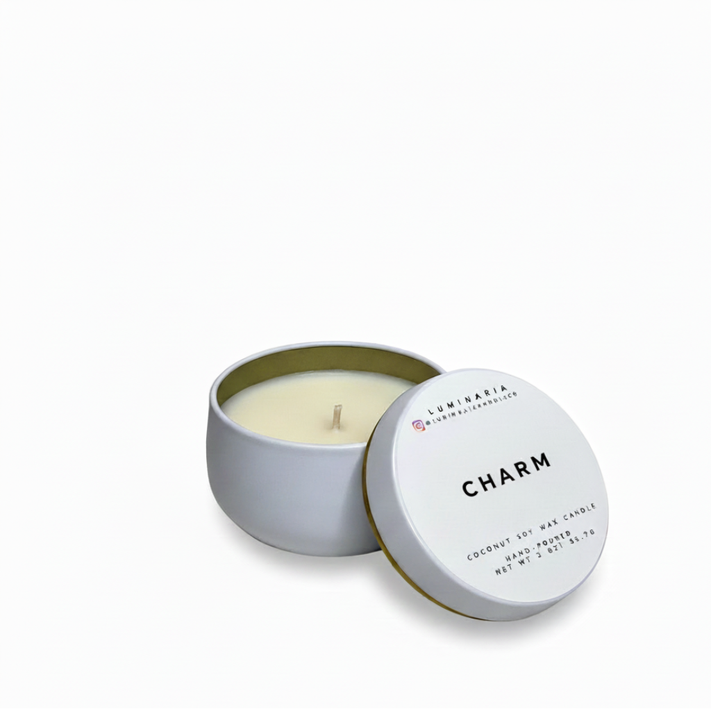 Open white metal tin candle with lid labeled 'Charm' placed on a white background