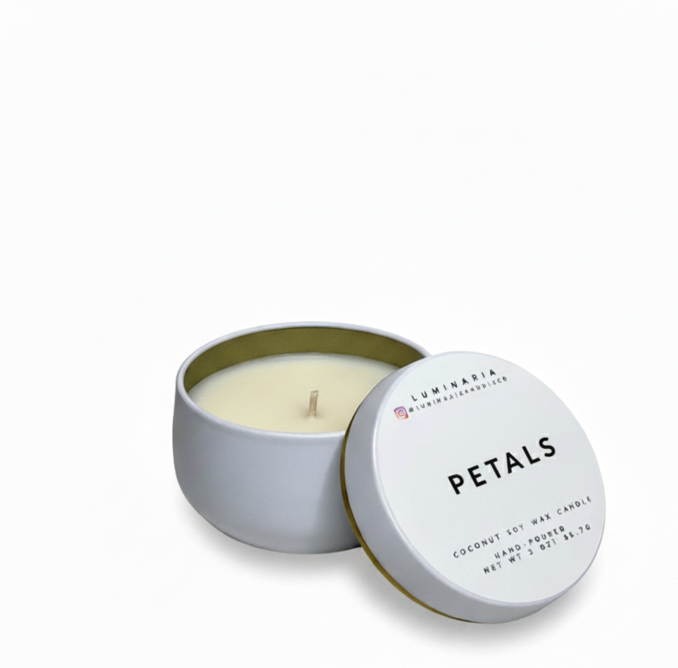 Open white metal tin candle with lid labeled 'Petals' placed on a white background